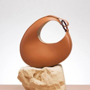 Caramel Curved Crescent Shoulder Bag with Integrated Wide Leather Shoulder Strap for Minimalist Neutral Daily Outfits